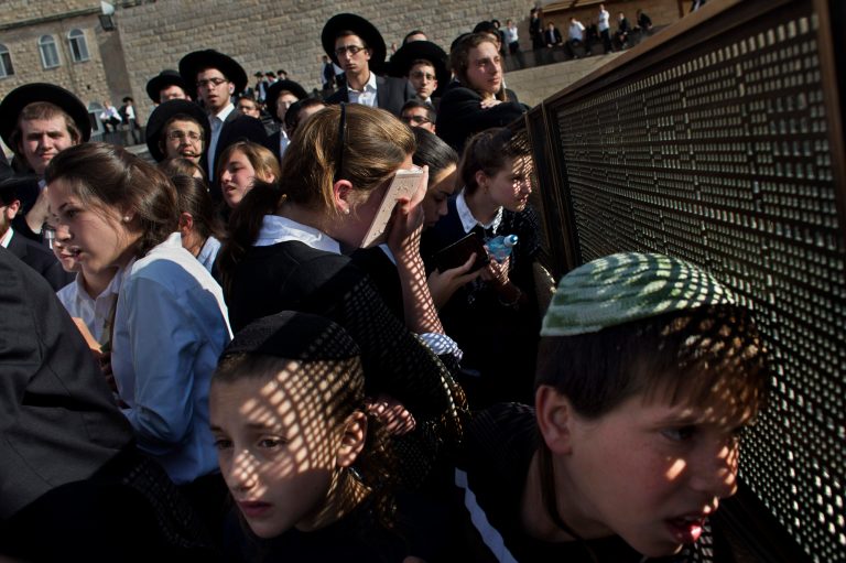 Ultra-orthodox Jewish people gather during a protest against a prayer organized by the 