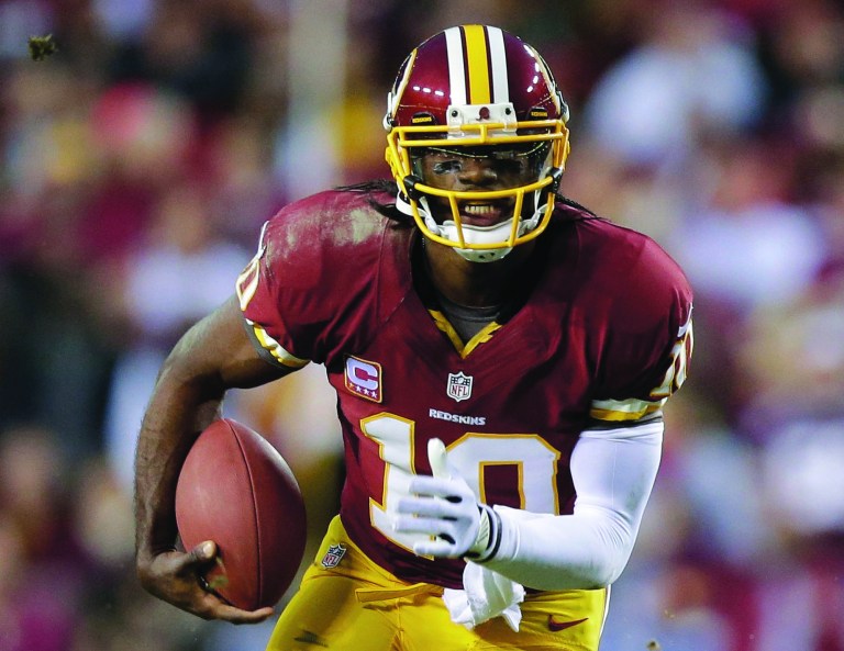 Evan Vucci/AP
The evolution of the Redskins' zone read option in the offseason may be stalled by Robert Griffin III's knee injury.