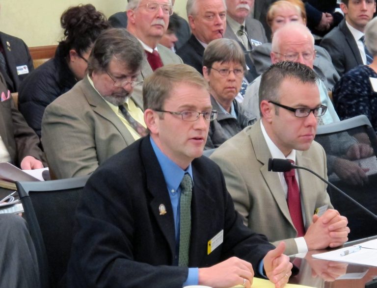 Sen. Chris Rothfuss, D-Laramie, left, testifies in favor of a bill he's sponsoring that would expand the Medicaid system in Wyoming. The Senate Labor Health and Social Services Committee started considering his bill Wed., Feb. 19, 2014, at the state Capitol in Cheyenne.  (AP Photo/Ben Neary)