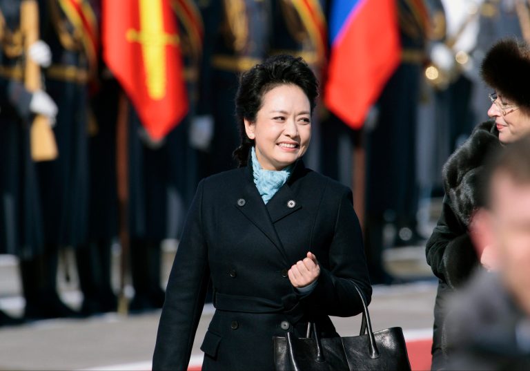 FILE - In this March 22, 2013 file photo, Chinese President Xi Jinping's wife Peng Liyuan smiles after arriving at the government airport Vnukovo II, outside Moscow, Russia. New Chinese first lady Peng is emerging as Chinese diplomacy's latest star. A well-known performer on state television, the glamorous Peng was featured prominently on Sunday's state media coverage of President Xi Jinping's activities in Russia. The visit is Xi's first since assuming the presidency earlier this month. (AP Photo/Ivan Sekretarev, File)