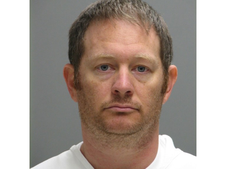 This booking photo provided by the Delaware Department of Justice shows Lee Robert Moore. Federal authorities say Moore, a Secret Service agent from Maryland, sent obscene images and texts to someone he thought was a young Delaware girl, sometimes doing it while on duty at the White House. (Delaware Department of Justice via AP)