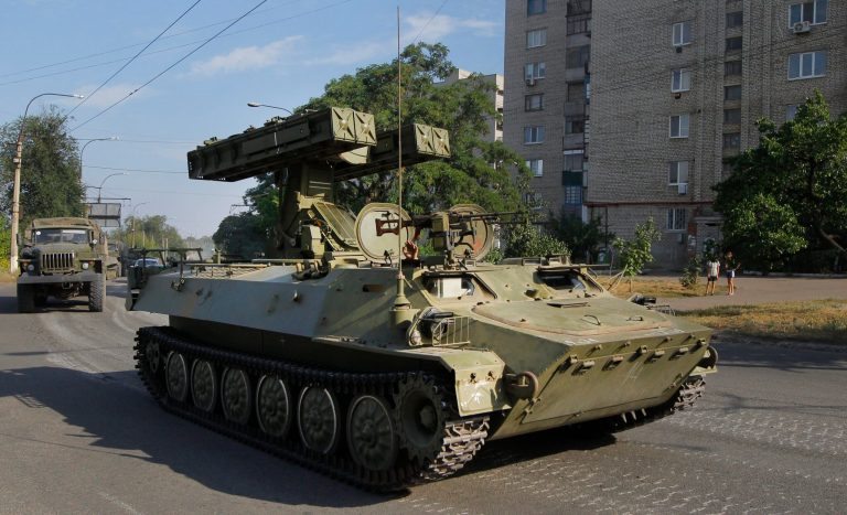 A Pro-Russian missile launcher drives in the town of Krasnodon, eastern Ukraine, Sunday, Aug. 17, 2014. A column of several dozen heavy vehicles, including tanks and at least one rocket launcher, rolled through rebel-held territory on Sunday.(AP Photo/Sergei Grits)