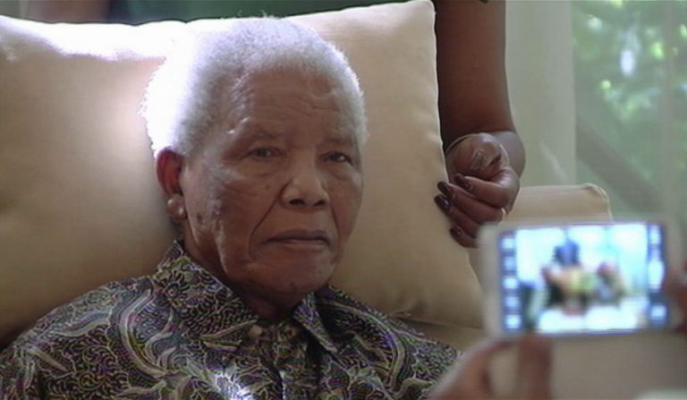 In this image taken from video, the ailing anti-apartheid icon Nelson Madela is filmed Monday April 29, 2013, more than three weeks after being released from hospital. Mandela was treated in hospital for a recurring lung infection. South African President Jacob Zuma visited the former leader on Monday, but Mandela does not appear to speak during the televised portion of the visit, as he sits in an armchair, his head propped up by a pillow with his cheeks showing what appear to be marks from a recently removed oxygen mask, although Zuma said he found Nelson Mandela 