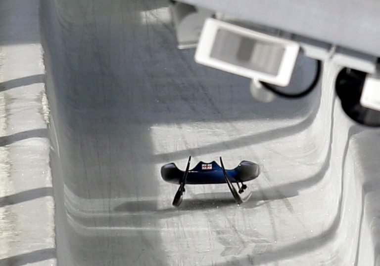 FILE - In this Friday, Feb. 12, 2010 file photo, the sled belonging to Nodar Kumaritashvili of Georgia sits empty on the track just after he crashed during a training run for the men's singles luge at the Vancouver 2010 Olympics in Whistler, British Columbia, Canada.  Kumaritashvili died when he lost control of his sled at nearly 145 kph (90 mph), flew off course and slammed into a steel pole. The horrifying death of Kumaritashvili cast a pall over the Vancouver Games, raised questions about track safety and design and changed Olympic luge forever.   (AP Photo/Michael Sohn, File)