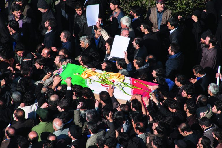 Iranian mourners carry the flag draped coffin of Gen. Hassan Shateri, during a funeral ceremony, in Tehran, Iran, Thursday, Feb. 14, 2013. Prominent Iranian politicians and clerics led mourners at a funeral Thursday for a senior commander of the country's powerful Revolutionary Guards who was killed this week while traveling from Syria to Lebanon, local media said. (AP Photo/Fars News Agency, Saeed Kariminejad)
