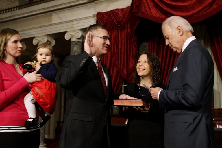 Sen. John Walsh, D-Mont., center, accompanied by his wife Janet, second from right, participates in a ceremonial swearing-in ceremony as Vice President Joe Biden reads the oath of office, Tuesday, Feb. 11, 2014, on Capitol Hill in Washington. Walsh daughter-in-law April Walsh holds his granddughter Kennedy at left.  (AP Photo/Lauren Victoria Burke)