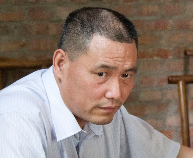 FILE - In this June 20, 2012 file photo, human rights lawyer Pu Zhiqiang works near his computer in Beijing. Chinese police have taken away the aide of prominent lawyer Pu, who was detained last week in a government clampdown on activists ahead of the 25th anniversary of the Tiananmen Square military suppression of protesters, an attorney said Thursday, May 15, 2014. Pu's aide, Qu Zhenhong, who is also his niece, was recently detained by Beijing police on suspicion of 