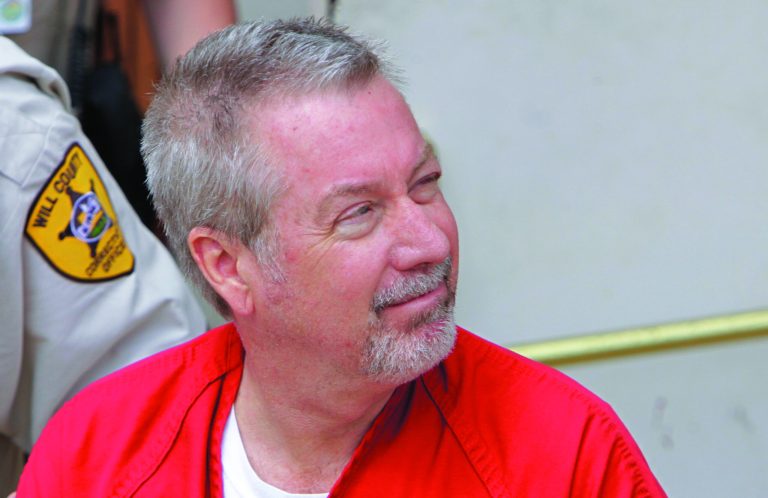 FILE - In this May 8, 2009 file photo, former Bolingbrook, Ill., police officer Drew Peterson leaves the Will County Courthouse in Joliet, Ill., after his arraignment on charges of first-degree murder in the 2004 death of his third wife Kathleen Savio. Lawyers for Drew Peterson on Wednesday, Aug. 15, 2012, have withdrawn a motion for a mistrial, allowing the former Illinois police officer's murder trial to go ahead. The defense attorneys' move follows several blunders by prosecutors seeking to prove that the 58-year-old Peterson killed his third wife, Kathleen Savio, in 2004. He's also a suspect in the 2007 disappearance of his fourth wife, Stacy Peterson, but never has been charged in her case. Peterson told the judge Wednesday he does not want a mistrial. (AP Photo/M. Spencer Green, File)