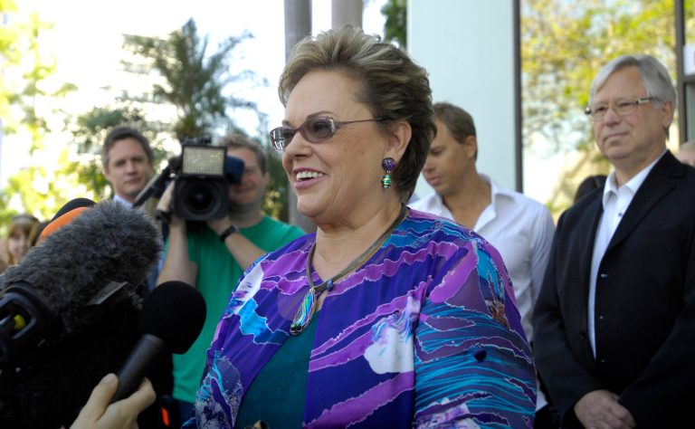   Lindy Chamberlain-Creighton speaks to the media as her ex-husband, Michael Chamberlain, right, listens outside a coroner's court in Darwin, Australia, Tuesday, June 12, 2012. Settling a notorious 1980 case that split the nation and led to a mistaken conviction, an Australian coroner ruled that a dingo took a baby from a campsite in the Outback, just as her mother said from the beginning. (AP Photo/AAP, Patrina Malone) AUSTRALIA OUT, NO SALES, NO ARCHIVES  
