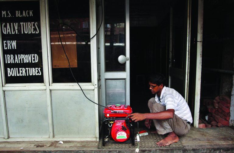 An Indian shopkeeper fixes an electric generator at his shop in New Delhi, India, Tuesday, July 31, 2012. India's energy crisis cascaded over half the country Tuesday when three of its regional grids collapsed, leaving 620 million people without government-supplied electricity in one of the world's biggest-ever blackouts. (AP Photo/Tsering Topgyal)