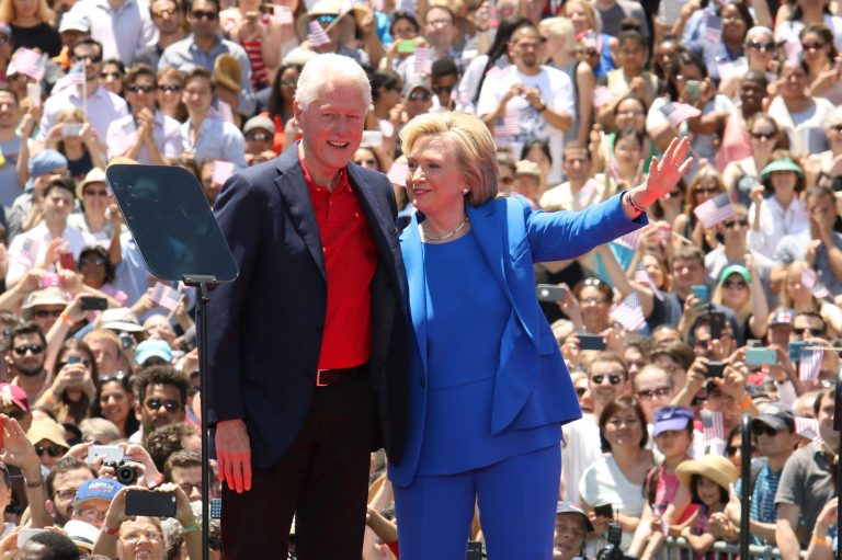 Hillary Rodham Clinton, right, and former President Bill Clinton appear on stage at the 