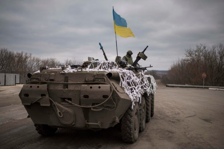 A Ukrainian military vehicle drives towards Debaltseve on the outskirts of Artemivsk, eastern Ukraine, Sunday, Feb. 8, 2015. (AP Photo/Evgeniy Maloletka)