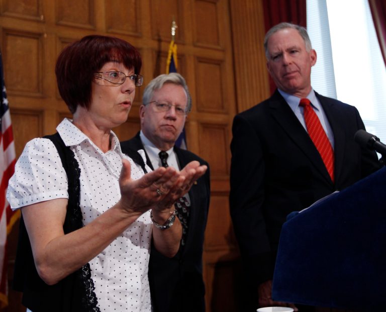   FILE - In this May 14, 2012 file photo, Elaine O'Toole of Tonawanda, N.Y., left, talks about a bill to protect the remains of crime victims during a news conference at the Capitol in Albany, N.Y. Bill sponsors Assemblyman Robin Schimminger, D-Kenmore, center, and Sen. Michael Ranzenhofer, R-Amherst, watch. Gov. Andrew Cuomo and legislative leaders said Monday, June 11, 2012, they have agreed on legislation that would end the power of abusive spouses to dictate what happens to the bodies of the wives or husbands theyâre accused of killing. (AP Photo/Mike Groll, File)  