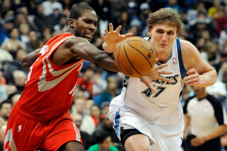  Houston Rockets' Toney Douglas, left, and Minnesota Timberwolves' Andrei Kirilenko, of Russia, chase the ball in the second half of an NBA basketball game, Wednesday, Dec. 26, 2012, in Minneapolis. The Rockets won 87-84. (AP Photo/Jim Mone)  
