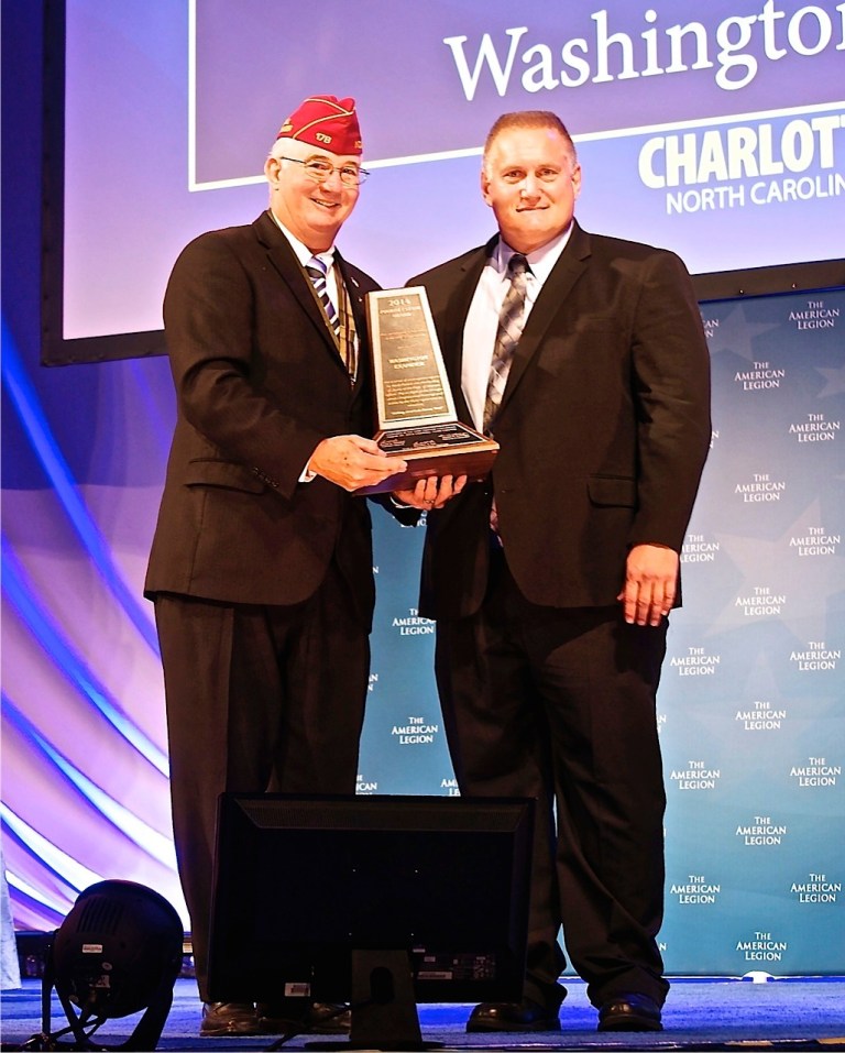 Mark Flatten, senior investigative reporter for the Washington Examiner, receives the American Legion's Fourth Estate Award. With him is Robert E. Newman, the Legion's national vice commander. Flatten was recognized for his 2013 series, 