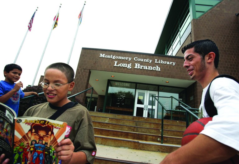 21mdLIBRARY

Christopher Amaya, 11 reads a comic book while neighborhood friends Juan Andino 17, right,  and Alfredo Diez, 12, left,  all of Silver Spring, hang out in front of the Long Branch Library in Silver Spring on Thursday, September 20, 2007. Andino, who was aware of increased law enforcement at the library said that he fells safe, and that even though incidents happen, that they are on rare occasion.  He characterized the incidents as fighting and cliques between kids about 15 years old. He was heading to the library to play chess.   Greg Whitesell/Examiner