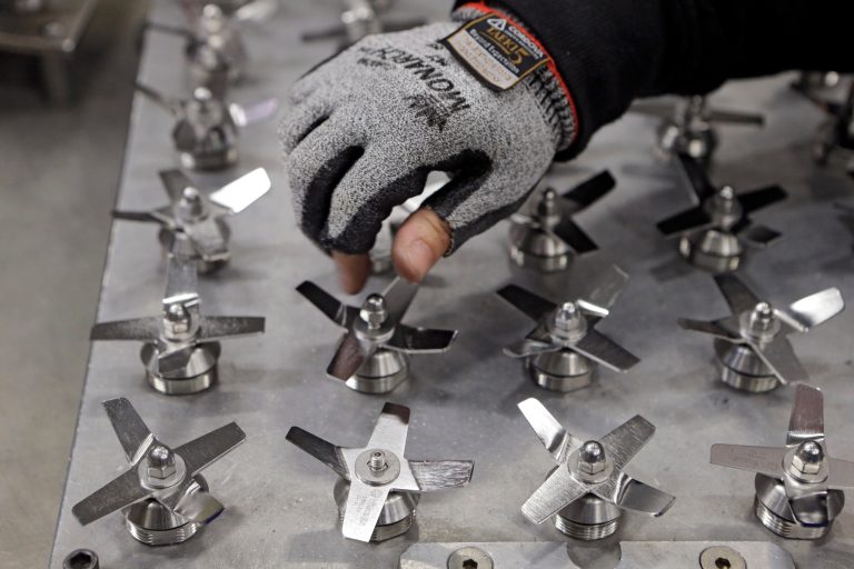 In this April 15, 2014 photo, Evelyn Morales assembles blender blades at the Vitamix  manufacturing facility in Strongsville, Ohio. The  Labor Department releases the Producer Price Index for June on Wednesday, July 16, 2014.(AP Photo/Mark Duncan)