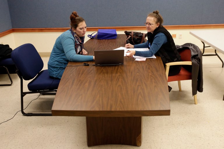 A health enrollment navigator helps a woman through the process of signing up for coverage under the Affordable Care Act.  (AP Photo/AJ Mast)