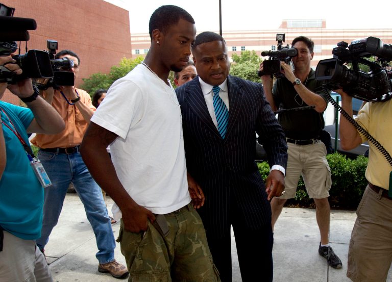   FILE - In this June 13, 2012 file photo, Chad Holley,18, center left, leaves the Harris County Jail with activist Quanell X after posting bail on a burglary charge, in Houston. Legal experts say the new arrest of Holley, who was allegedly beaten by several Houston police officers during an incident caught on video, could pose problems for prosecutors who are still trying to get convictions in the case. (AP Photo/Houston Chronicle, Brett Coomer, File)  