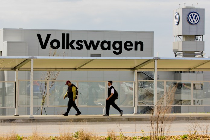Workers walk by the Volkswagen AG plant in Chattanooga, Tenn., in March 2012. (AP Photo/Erik Schelzig, file)