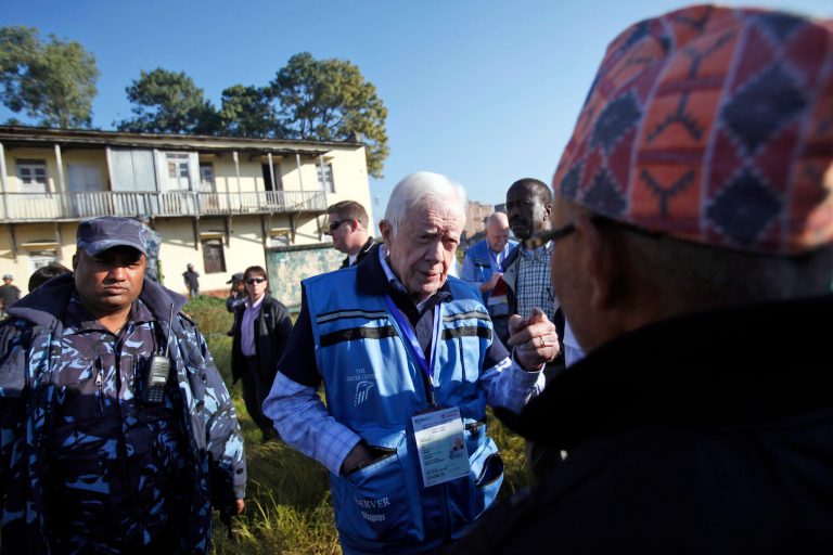 President Jimmy Carter, center, visits a polling station in Katmandu, Nepal in 2013. The Carter Center, an international poll observation organization, headed by the former president, had mobilized election observers for the election. (AP Photo/Niranjan Shrestha)