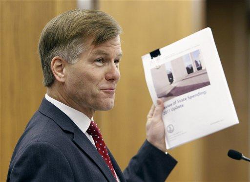 Virginia Gov. Bob McDonnell holds a JLARC report on state spending as he presents his budget before a joint session of the House and Senate money committees at the Capitol in Richmond, Va., Monday, Dec. 19, 2011.