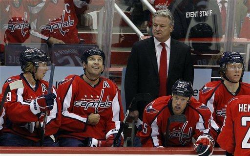 Washington Capitals head coach Dale Hunter watches his players on the bench during the first period of an NHL hockey game against the Ottawa Senators in Washington, Saturday, Dec. 3, 2011.


