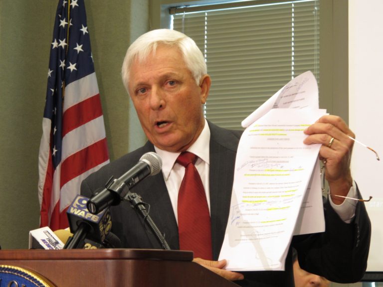 Louisiana Attorney Gen. Buddy Caldwell holds a copy of his office's lawsuit against State Farm on Tuesday, Aug. 19, 2014, in Baton Rouge, La. The lawsuit accuses the insurance company of steering customers who have been in accidents to repair shops that prioritize cheap fixes over safety. (AP Photo/Melinda Deslatte)