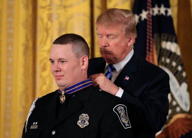 President Donald Trump awards public safety Medal of Valor to Officer Andrew Hopfensperger, Jr., of Antigo (Wis.) Police Department during a ceremony in the East Room of the White House, Tuesday, Feb. 20, 2018, in Washington. (AP Photo/Manuel Balce Ceneta)