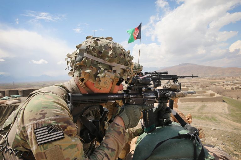 Sgt. Kurtis Scheinder from Detroit with the U.S. Army's 2nd Battalion 87th Infantry Regiment, 3rd Brigade Combat Team, 10th Mountain Division keeps watch from inside an Afghan National Army outpost during a patrol outside of Forward Operating Base Shank on March 29, 2014 near Pul-e Alam, Afghanistan. (Photo by Scott Olson/Getty images)