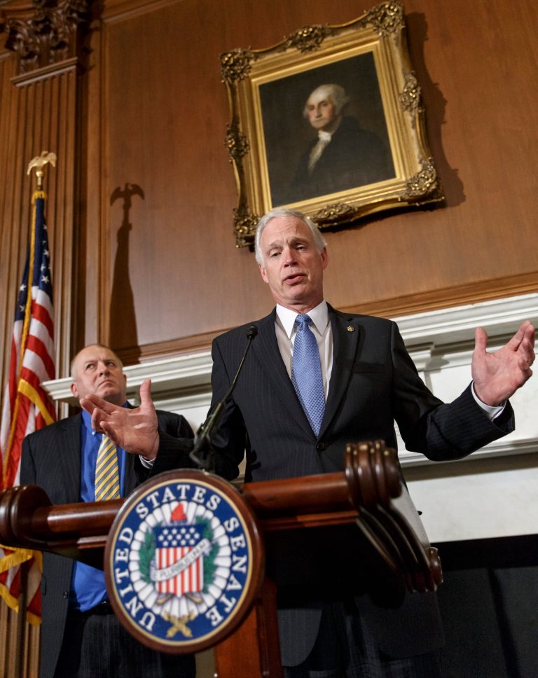 Sen. Ron Johnson, R-Wis., right, accompanied by attorney Rick Esenberg, left, announces that he has filed a lawsuit to block the federal government from helping to pay for health care coverage for members of Congress and their staffs, Monday, Jan. 6, 2014, during a news conference on Capitol Hill in Washington. Johnson says that members of Congress and their staffs are getting special treatment under the health care law. The lawsuit would would force Congress and its staffers to purchase their insurance from the federal health care exchanges without exemptions carved out by the Office of Personnel Management. (AP Photo/J. Scott Applewhite)