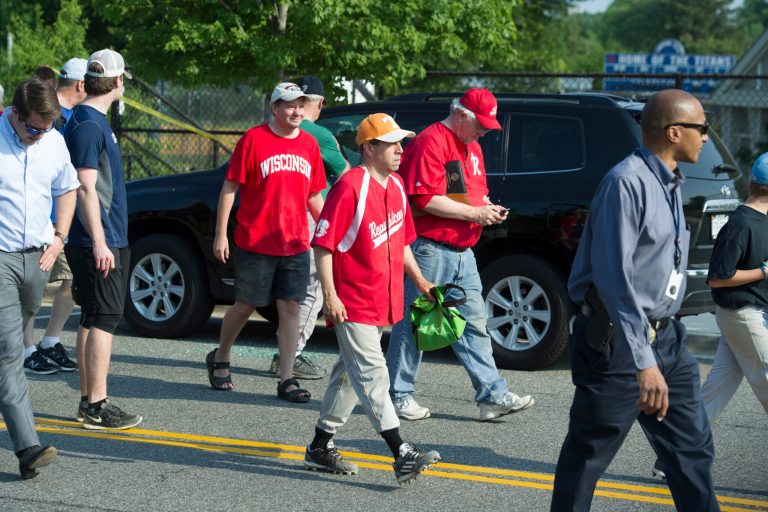 Rep. Chuck Fleichsmann, R-Tenn., center, foreground, Rep. Joe Barton, R-Texas, manager of the Republican team, center, background, and others, leave the scene of a shooting in Alexandria, Va., Wednesday, June 14, 2017, where House Majority Whip Steve Scalise of La., and others were shot during a Congressional baseball practice. (AP Photo/Cliff Owen)