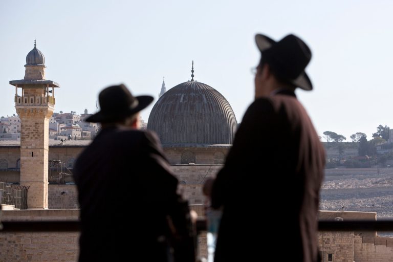 Ultra-Orthodox Jewish men stand in front of the Al-Aqsa Mosque in Jerusalem's Old City. The site, known as the Temple Mount, was the subject of a New York Times article thatÂ questioned whether two ancient Jewish temples ever actually stood there.Â (AP Photo/Sebastian Scheiner, File)