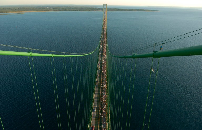 FILE--In this Sept. 5th, 2005 file photo, thousands of people walk south from St. Ignace across the five-mile Mackinac Bridge during the 48th annual event on the span, which connect the Upper and Lower Peninsulas of Michigan between Lakes Michigan and Huron. Michigan officials are questioning the safety of two Enbridge Inc., pipelines that carry oil beneath the waterway linking Lakes Huron and Michigan. (AP Photo/John L. Russell)