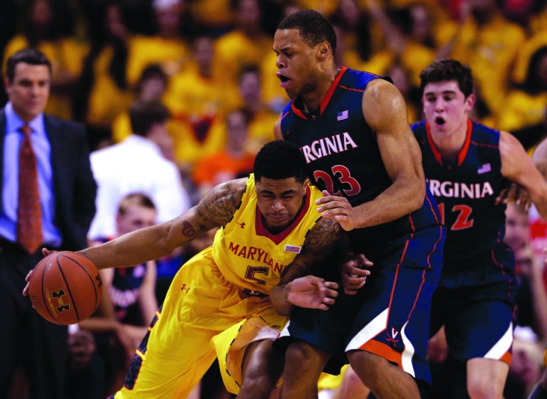 Patrick Semansky/AP
Nick Faust and Maryland were outrebounded for the first time this season in a loss to Justin Anderson and Virginia on Sunday.