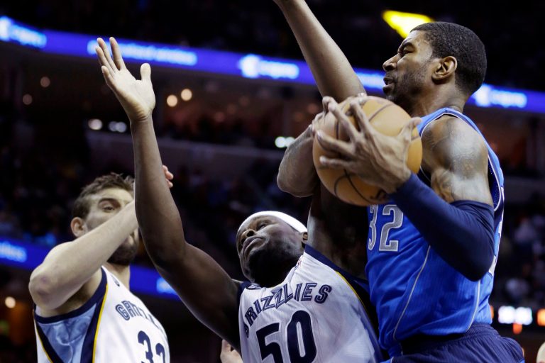   Dallas Mavericks' O.J. Mayo (32) pulls down an offensive rebound over Memphis Grizzlies' Marc Gasol (33), of Spain, and Zach Randolph (50) during the first half of an NBA basketball game in Memphis, Tenn., Friday, Dec. 21, 2012. (AP Photo/Danny Johnston)  