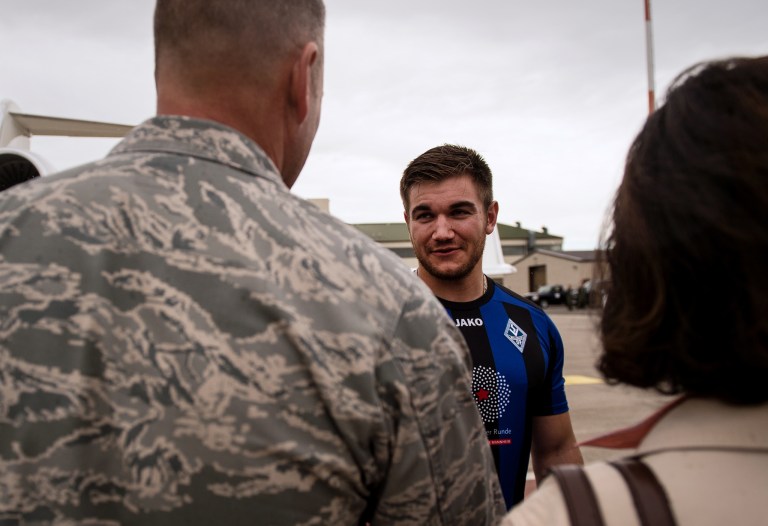 In this Aug. 24, 2015 picture, provided by U.S Airforce Ramstein, Oregon National Guardsman Aleksander Skarlatos, right, meets Brig. Gen. Jon T. Thomas, 86th Airlift Wing commander, as he arrives at Ramstein Air Base, Germany. (Staff Sgt. Sara Keller/U.S. Air Force via AP)