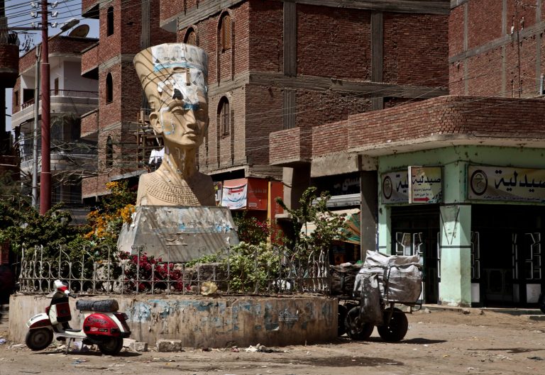In this Wednesday, March 27, 2013 photo, A defaced statue of Nefretti, adorns the intersection of the main street in Samalout, Minya Province, Egypt. Egypt's Christians, followers of one of the world's most ancient churches, make up about 10 percent of the country's estimated 90 million people. (AP Photo/Thomas Hartwell)