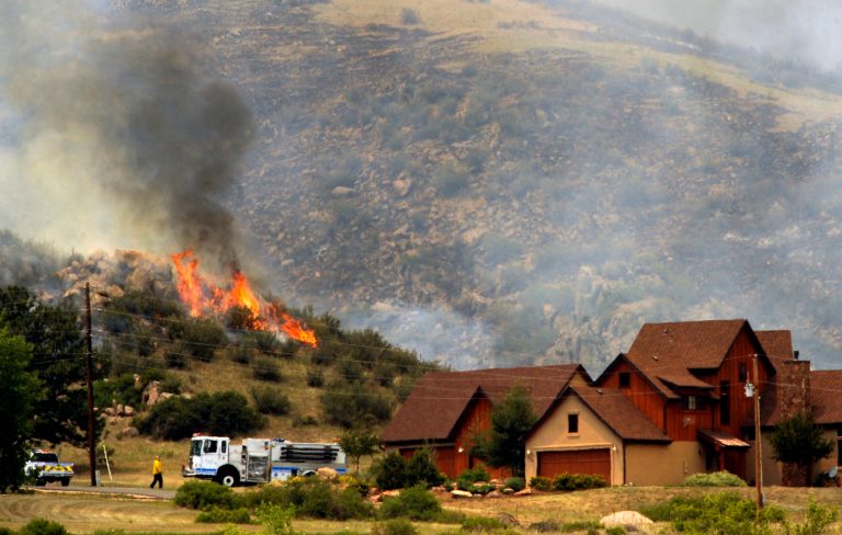   Poudre Fire Authority crews battle a wildfire in a mountainous area about 15 miles west of Fort Collins, Colo., on Sunday, June 10, 2012. Firefighters on Sunday were fighting wildfires that have spread quickly in parched forests in Colorado and New Mexico, forcing hundreds of people from their homes and the evacuation of wolves from a sanctuary. The Colorado fire grew to 22 square miles within about a day of being reported and has destroyed or damaged 18 structures. (AP Photo/The Denver Post, Helen H. Richardson) MAGS OUT; TV OUT; INTERNET OUT; MANDATORY CREDIT  