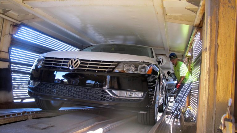 The first rail shipment of 2012 Volkswagen Passats built at the automaker's plant in Chattanooga is loaded aboard train cars Wednesday, June 29, 2011. (AP Photo/Bill Poovey)