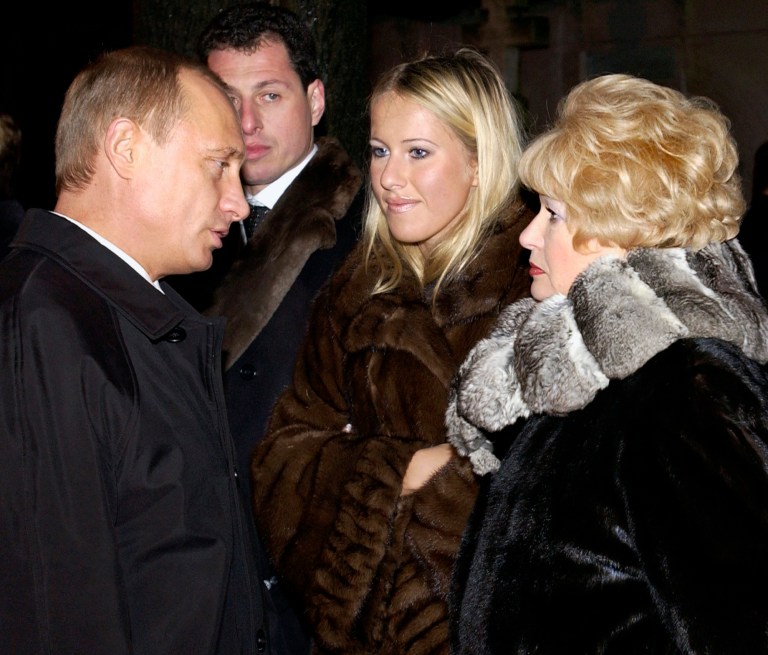   FILE - In this Saturday, Nov. 29, 2003 file photo, Russian President Vladimir Putin, left, speaks with Lyudmila Narusova, right, widow of former St. Petersburg mayor Anatoly Sobchak, and Sobchak's daughter Ksenia, as he visited the grave of Anatoly Sobchak at a cemetery in St. Petersburg, Russia. Ksenia Sobchak, the 30-year-old blond socialite and TV personality said âIâm Ksenia Sobchak, and Iâve got something to lose. But Iâm here.â when she began her unlikely foray into political activism by taking the stage at a huge anti-Putin rally in December. Once considered untouchable because of her familyâs close personal ties to President Vladimir Putin, Sobchak has since found that she does indeed have something to lose, as her apartment has been raided by police and she has been called in for interrogation. It has been a quick change of fortune for Russiaâs It Girl, who like many Russians of her generation experienced a civic awakening after many years of political passivity. (AP Photo/ITAR-TASS, Presidential Press Service, file)  