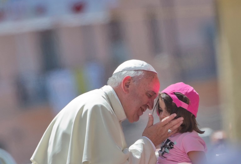 Pope Francis  kisses a girl in front the Duomo of Cassano allo Jonio, southern Italy, Saturday, June 21, 2014. Pope Francis is paying a one day visit to Castrovillari, Sibari, and Cassano allo Jonio, in the Calabria region of Italy. (AP Photo/Alessandra Tarantino)