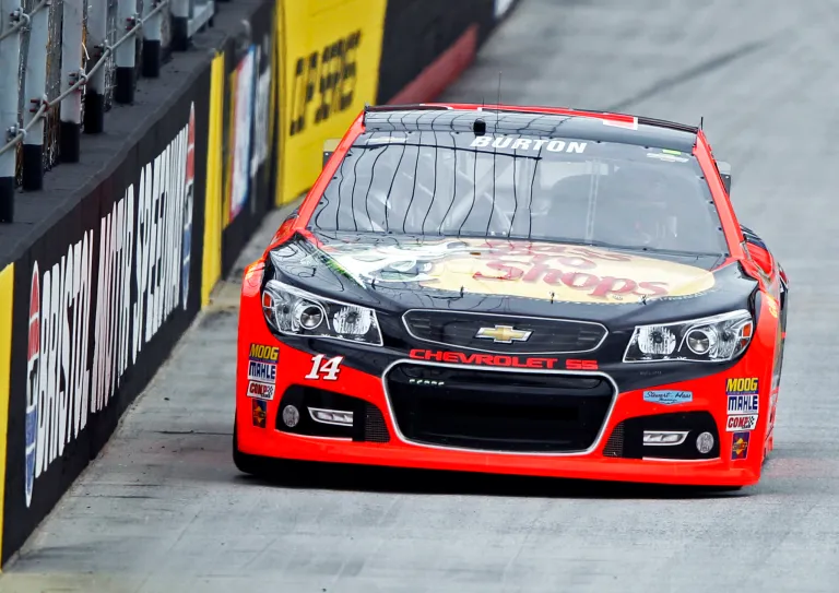 Driver Jeff Burton (14) drives down the back straight during practice for the Irwin Tools Night Race NASCAR Sprint Cup Series auto race at Bristol Motor Speedway on Friday, Aug. 22, 2014, in Bristol, Tenn. (AP Photo/Wade Payne)
