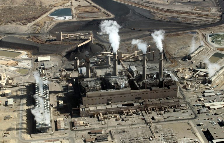 FILE - This Nov. 9, 2009, file photo, shows the coal-fired San Juan Generating Station near Farmington, N.M. The Santa Fe-based group New Energy Economy is challenging the estimated costs of a plan by PNM to close two units at the power plant and replace the power with a mix of coal, nuclear and solar energy. The group contends PNM didn't include more than a half-billion dollars of ongoing capital expenditures in the calculations and failed to weigh the costs of environmental regulations and the disposal of coal ash waste generated by the power plant. (AP Photo/Susan Montoya Bryan, File)