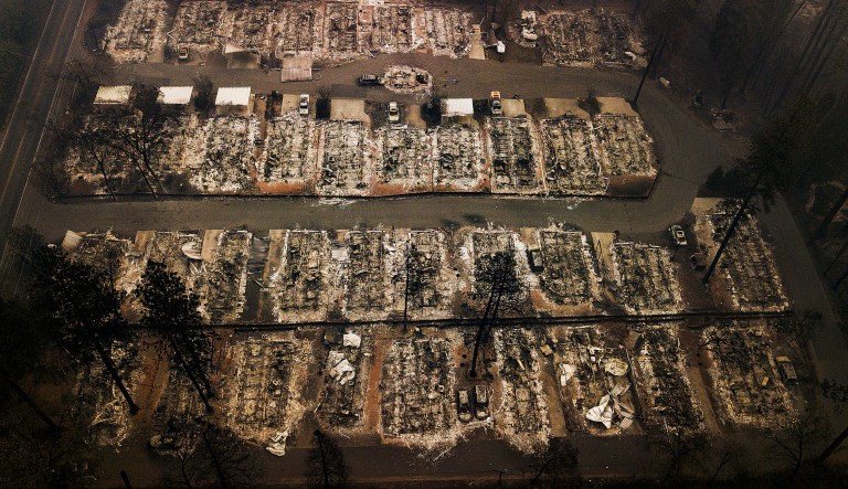 FILE - This Nov. 15, 2018, aerial file photo shows the remains of residences leveled by the Camp wildfire in Paradise, Calif. Pacific Gas & Electric Corp. has received approval to establish a $105 million fund to help survivors of recent California wildfires started by the utility's power lines. A federal judge overseeing PG&E's bankruptcy case approved the utility's "wildfire assistance program" on Wednesday, May 22, 2019.