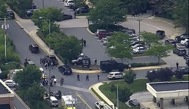 In this frame from video, people leave the Capital Gazette newspaper after multiple people have been shot on Thursday, June 28, 2018, in Annapolis, Md.