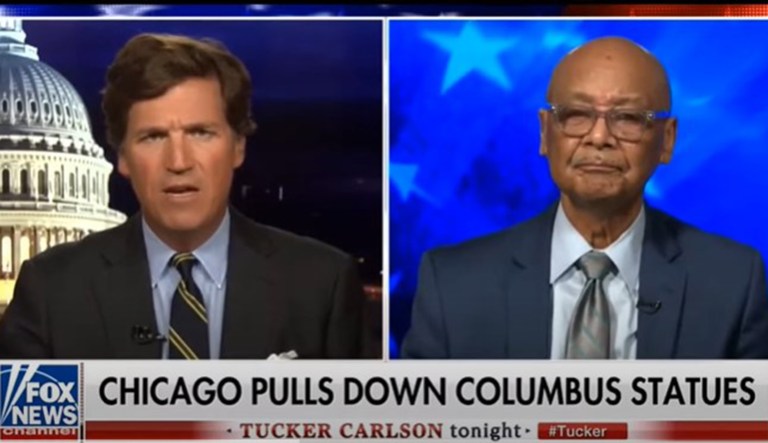 Tucker Carlson and Robert Woodson are seen.