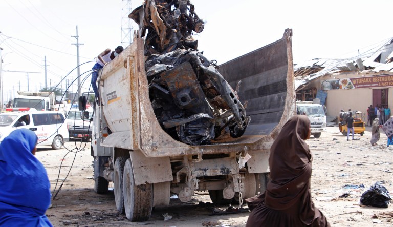 A truck carries wreckage of car used in car bomb in Mogadishu, Somalia, Saturday, Dec, 28, 2019.A police officer says a car bomb targeting a tax collection center has detonated at a security checkpoint during the morning rush hour in Somalia's capital.