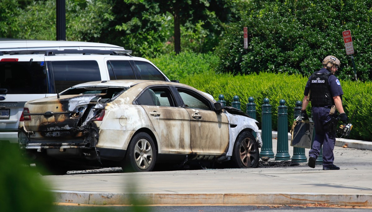 Injured man in custody after police car set on fire outside of Supreme ...