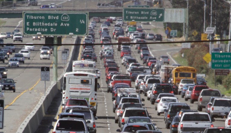 In this May 26, 2011, file photo, a motorcyclist rides between lanes as traffic backs up on U.S. Highway 101 in Mill Valley, Calif.
